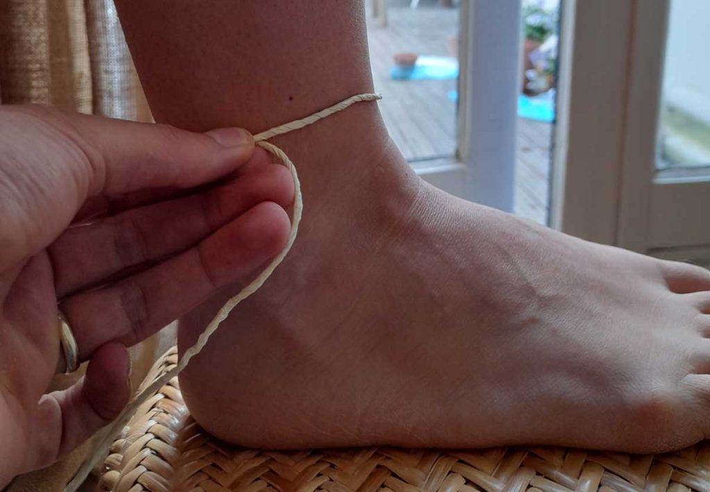 measure anklet size with string and ruler