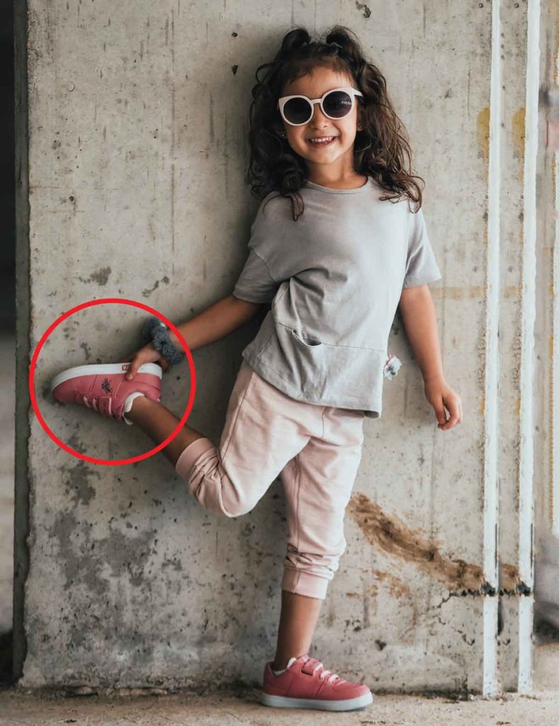 child holding shoe size