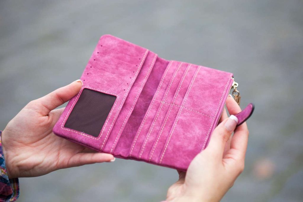 women holding pink wallet with photo